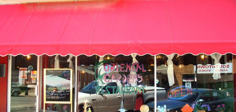 Oriental Gardens storefront with a red awning in Princeton, Illinois.