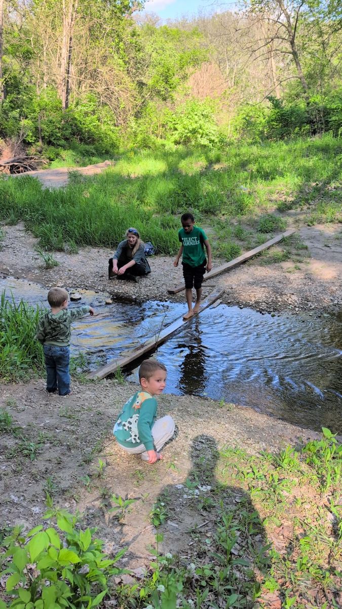 Visitors exploring the creek at Hungry World Farm
