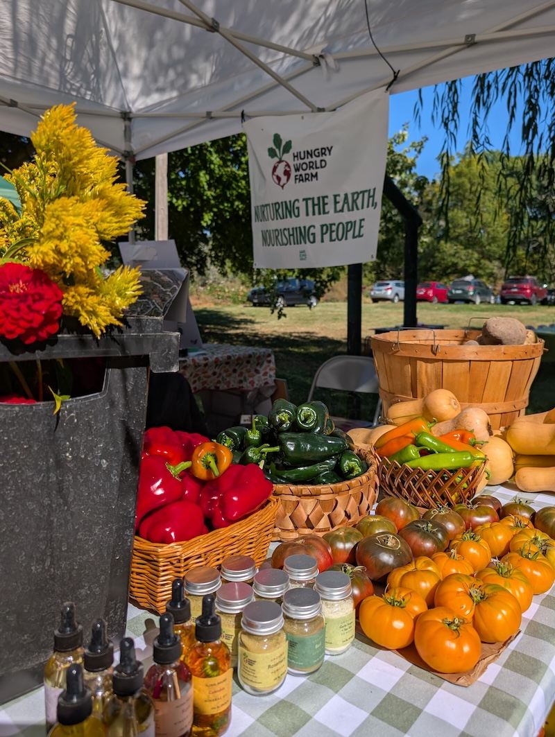 Hungry World Farm’s produce and flowers at a market stand