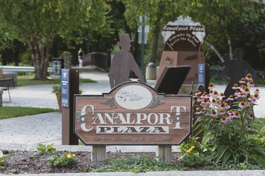 Canalport Plaza sign, flowers and interpretive displays at Canalport Park in Morris.