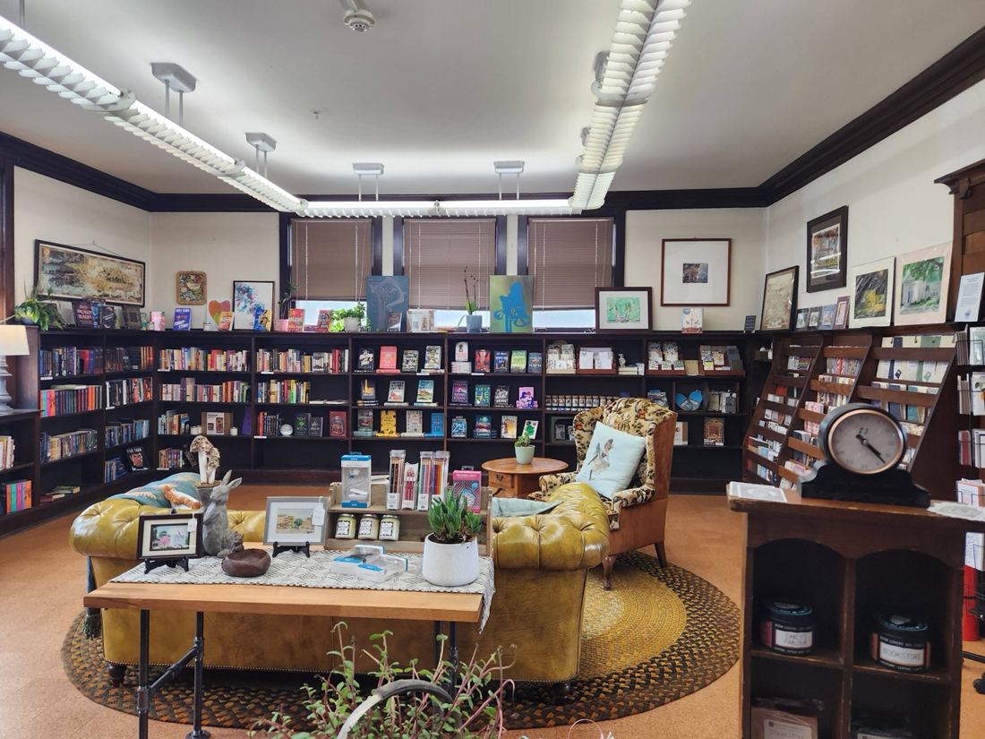 Bookshelves and reading chairs inside True Leaves Bookshop